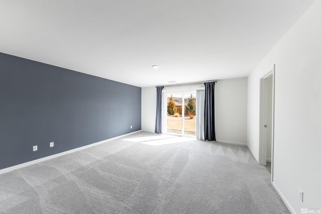 carpeted spare room with baseboards