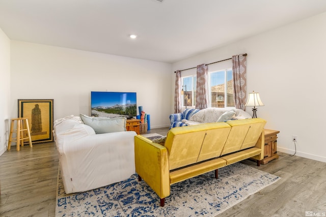 living area with recessed lighting, baseboards, and wood finished floors