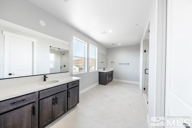 bathroom with two vanities, a sink, visible vents, baseboards, and a stall shower