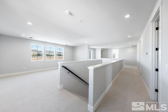 hallway with recessed lighting, visible vents, light carpet, an upstairs landing, and baseboards