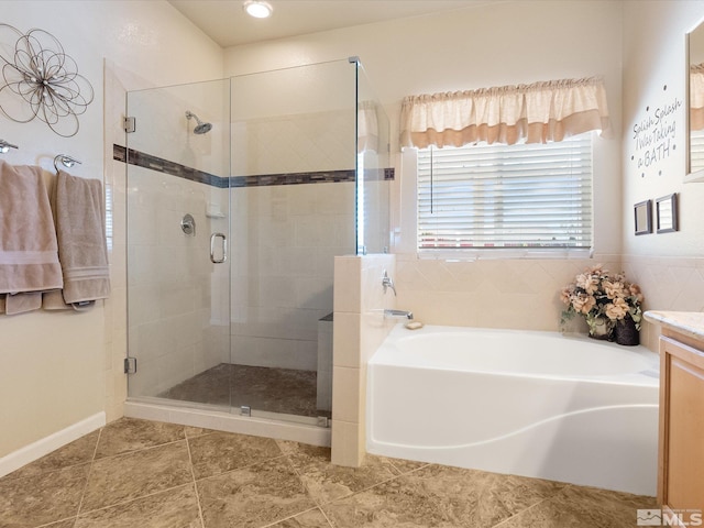 full bathroom with a stall shower, tile patterned flooring, vanity, and a bath