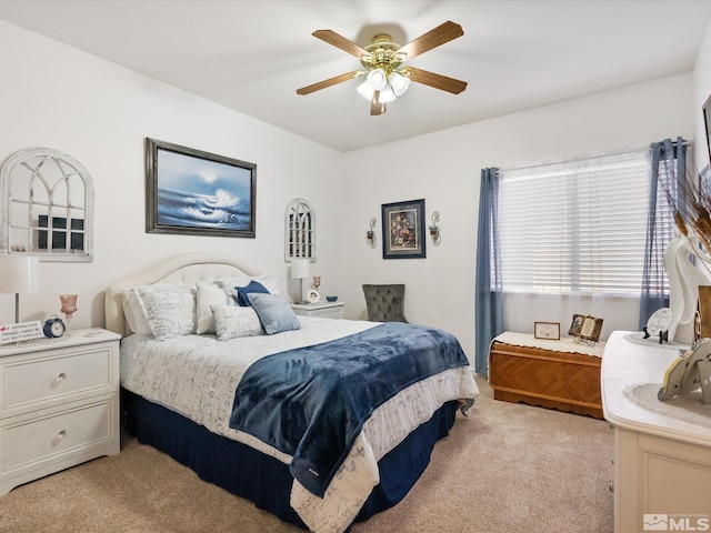 bedroom featuring light carpet and ceiling fan