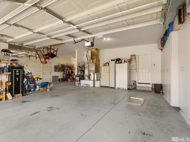 garage with freestanding refrigerator and a garage door opener