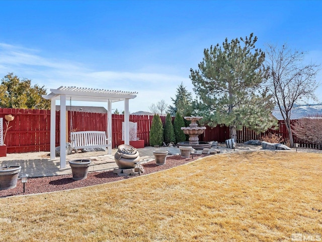 view of yard featuring a fenced backyard, a patio, and a pergola