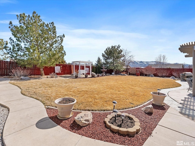 view of yard with a patio area, fence, and a pergola