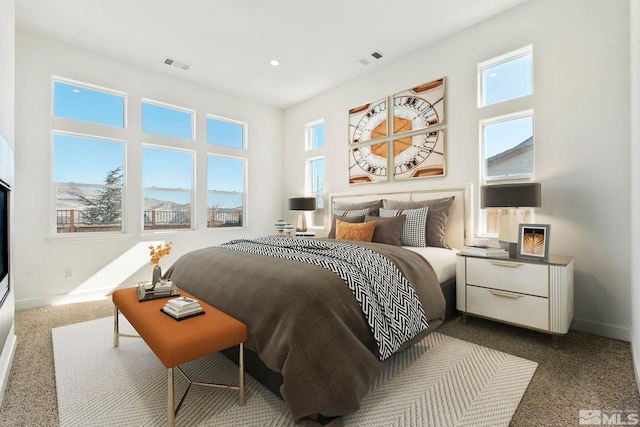 bedroom with baseboards, visible vents, dark colored carpet, and recessed lighting