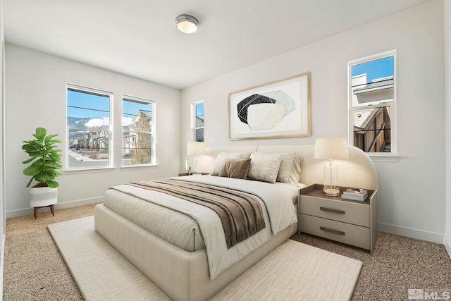 bedroom with carpet floors and baseboards