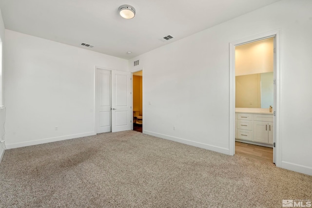 unfurnished bedroom featuring carpet floors, visible vents, and baseboards