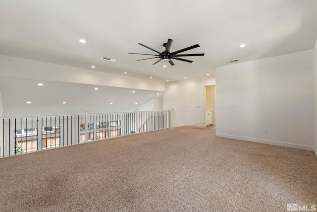 unfurnished room with recessed lighting, light carpet, visible vents, and baseboards