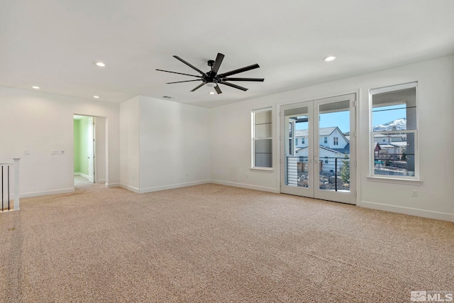 empty room featuring baseboards, light colored carpet, a ceiling fan, and recessed lighting