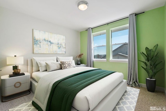 bedroom featuring carpet floors and baseboards