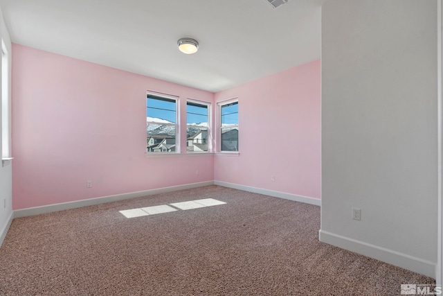 carpeted empty room with visible vents and baseboards