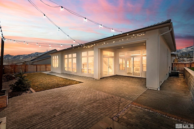 back of house featuring cooling unit, a fenced backyard, a patio, and stucco siding