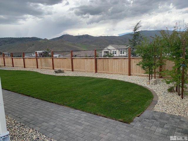 view of yard featuring a fenced backyard and a mountain view