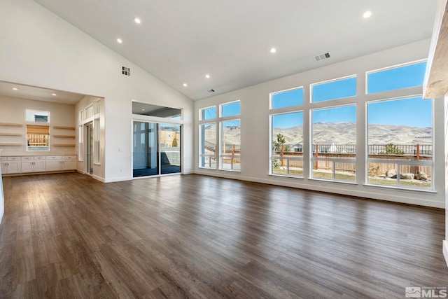 unfurnished living room featuring high vaulted ceiling, visible vents, dark wood-type flooring, and recessed lighting