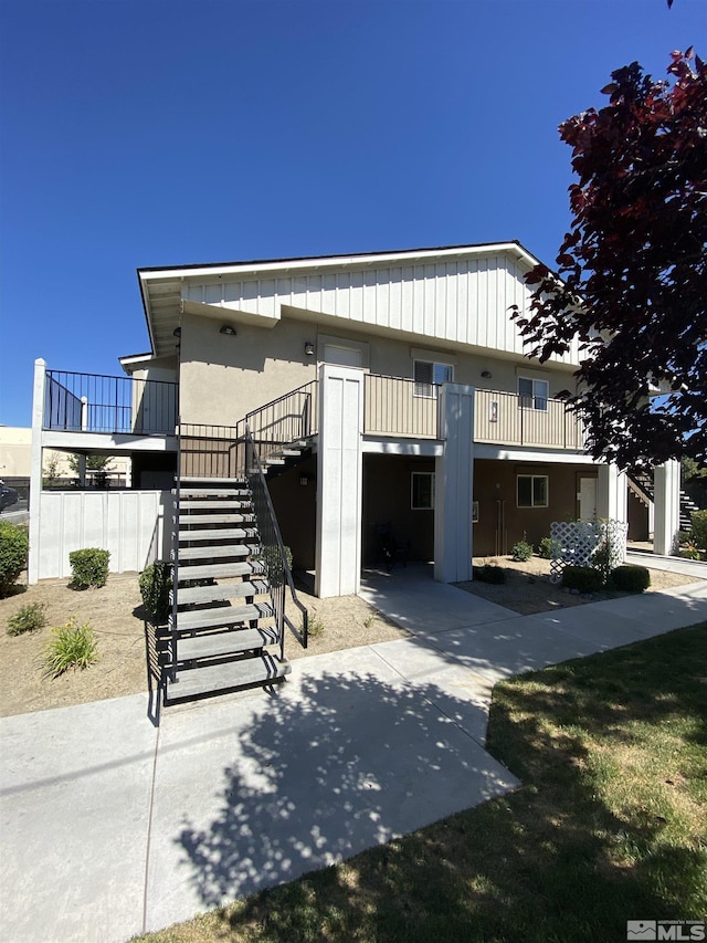 view of front of home featuring stairs and a deck