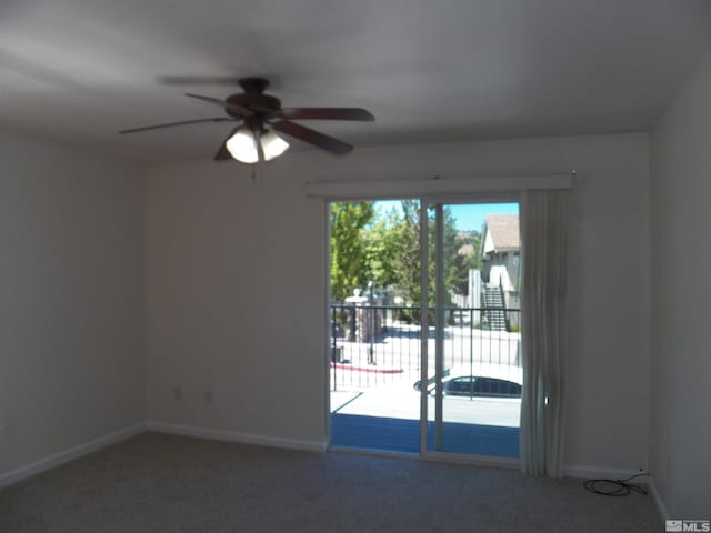 empty room featuring a ceiling fan, carpet, and baseboards