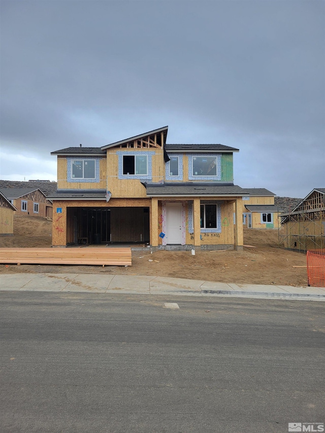 view of front of home with a garage, driveway, and a deck