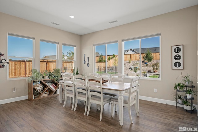 dining room featuring recessed lighting, wood finished floors, visible vents, and baseboards