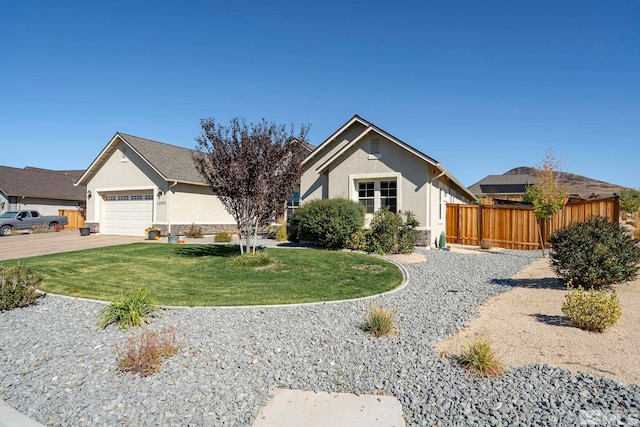 view of front of property with stucco siding, fence, a garage, driveway, and a front lawn