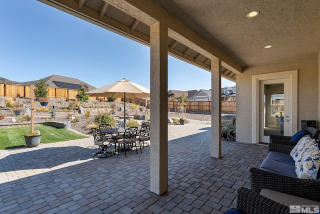 view of patio featuring outdoor dining area and a fenced backyard