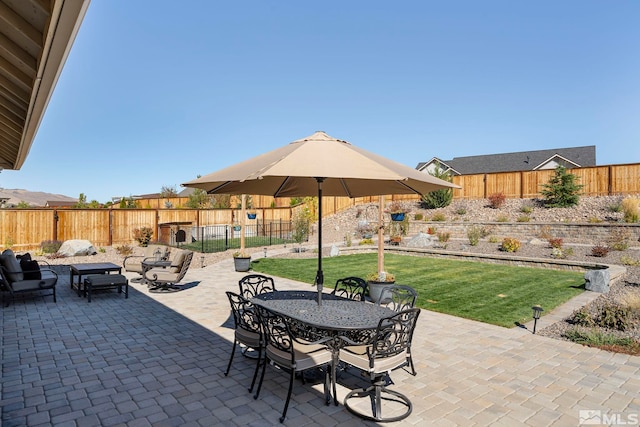 view of patio featuring outdoor dining area and a fenced backyard