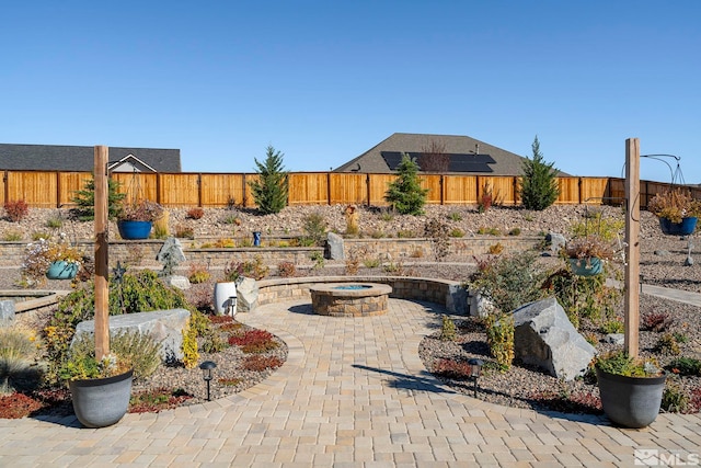 view of patio / terrace featuring an outdoor fire pit and a fenced backyard