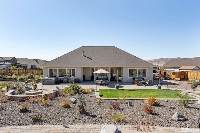 back of property featuring a yard, a patio, an outdoor fire pit, and fence