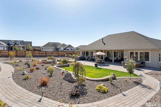 rear view of property with a patio, a yard, fence, and a residential view