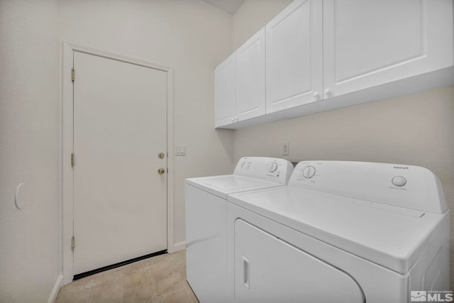 laundry area featuring cabinet space, washer and clothes dryer, baseboards, and light tile patterned floors