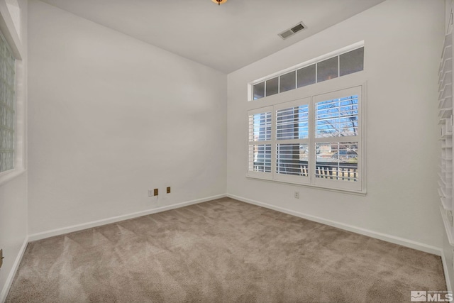 carpeted empty room with baseboards and visible vents