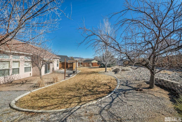 view of yard featuring fence and a patio