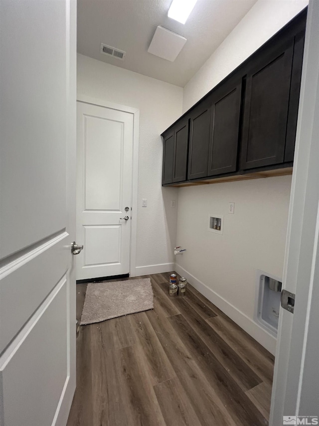 laundry room with cabinet space, baseboards, visible vents, dark wood-type flooring, and washer hookup