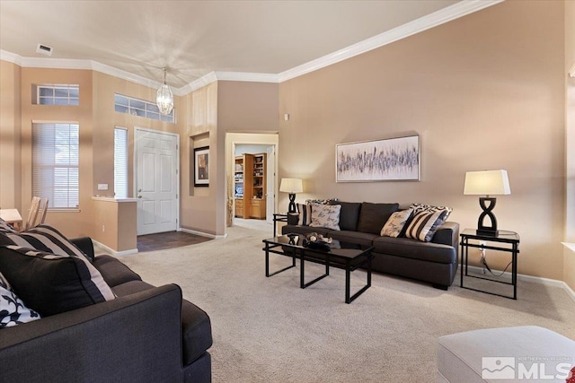 living area featuring carpet, crown molding, and baseboards