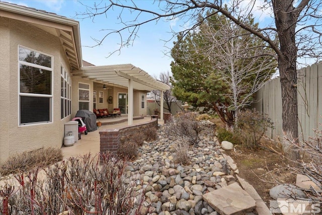 view of yard featuring a fenced backyard, a patio, and a pergola