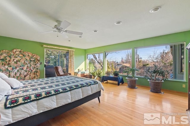 bedroom with wood finished floors and a ceiling fan