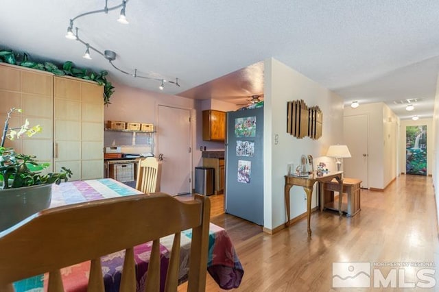 kitchen featuring light wood-style floors and rail lighting