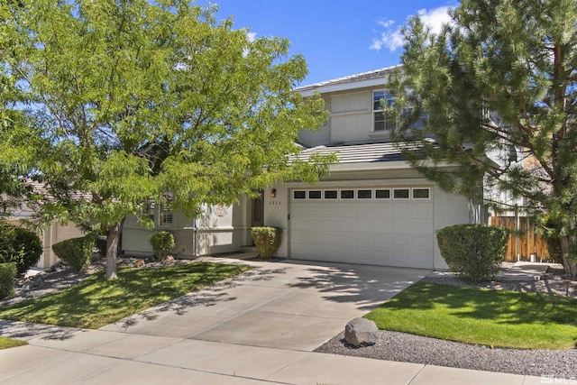 view of front facade with a garage, a tile roof, fence, driveway, and stucco siding