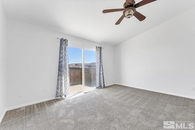 carpeted spare room with ceiling fan and baseboards