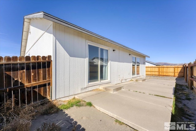 rear view of property with a patio area and a fenced backyard