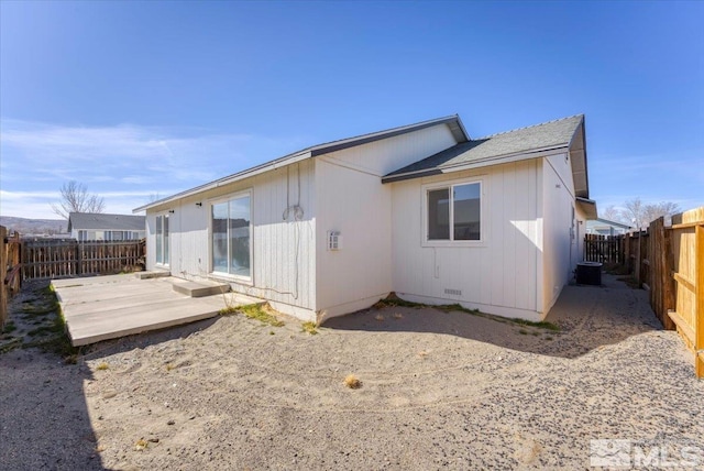 back of house with crawl space, a patio area, and a fenced backyard