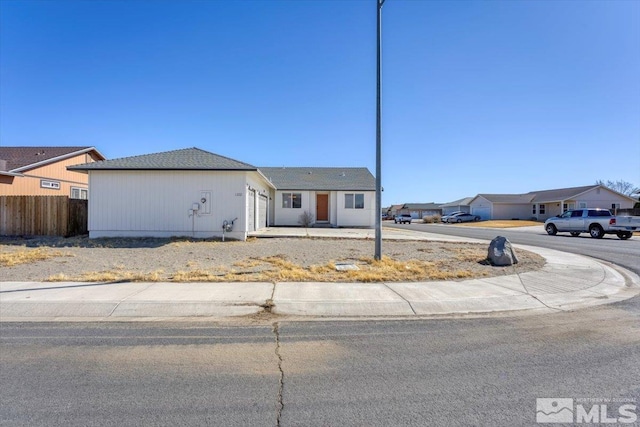 view of front of property featuring a residential view and fence