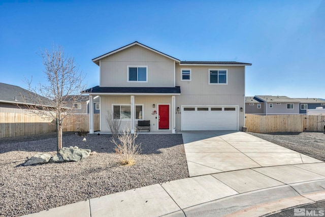 traditional-style home featuring a garage, concrete driveway, fence, and a porch