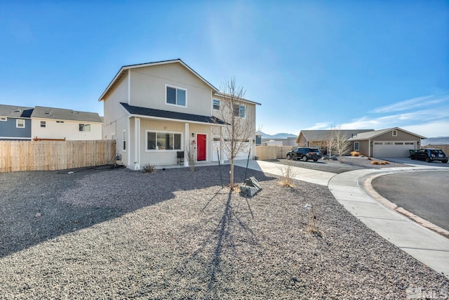 traditional-style home featuring fence and concrete driveway