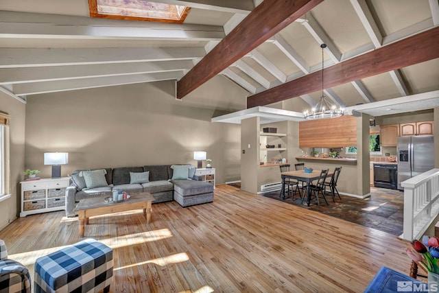 living area featuring lofted ceiling with beams, an inviting chandelier, and wood finished floors