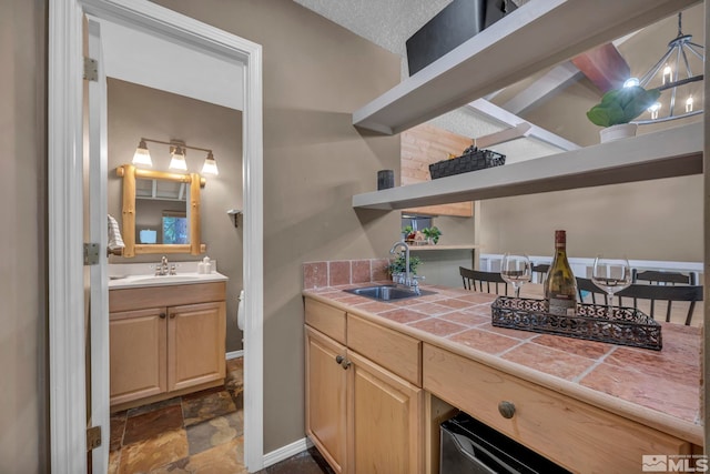 bathroom featuring stone finish floor, vanity, and baseboards