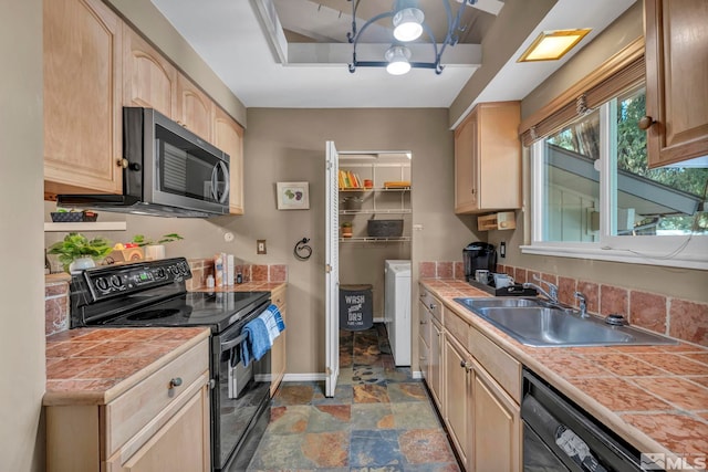 kitchen featuring light brown cabinets, a sink, tile countertops, and black appliances