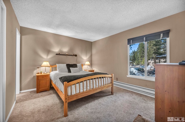 bedroom featuring light carpet, a textured ceiling, a baseboard radiator, and baseboards