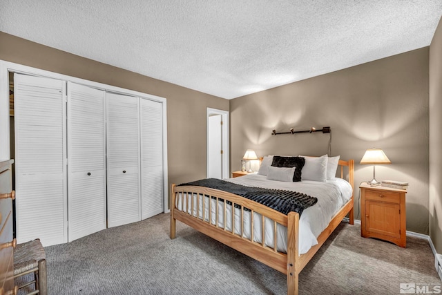 bedroom featuring a textured ceiling, a closet, and light colored carpet