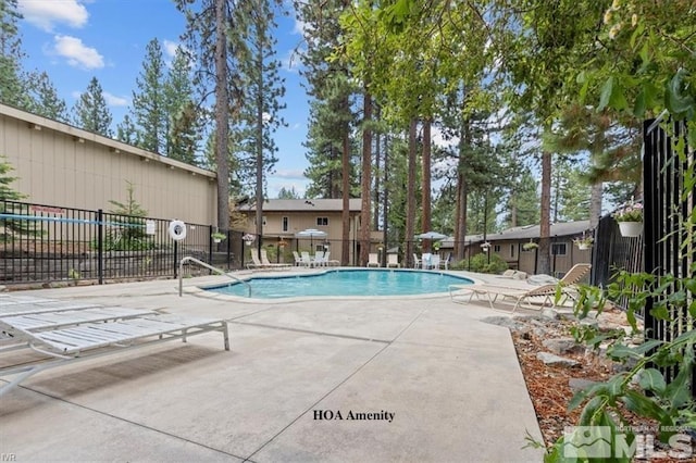 pool with fence and a patio